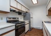 Thumbnail 1 of 19 - a kitchen with white countertops and stainless steel appliances