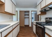 Thumbnail 3 of 19 - the preserve at ballantyne commons apartment kitchen and hallway with stove and counter tops