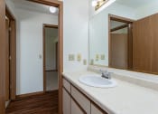 Thumbnail 13 of 19 - a bathroom with a sink and a mirror in a house