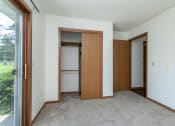 Thumbnail 15 of 19 - an empty room with a door to a closet and a window
