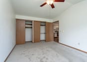 Thumbnail 7 of 19 - an empty living room with white walls and a ceiling fan