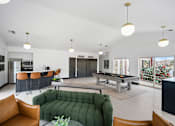 Thumbnail 17 of 60 - a living room with a pool table and a green couch