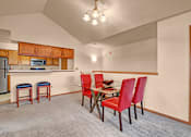 Thumbnail 27 of 44 - A kitchen with a table and chairs.