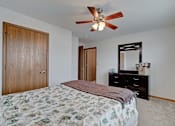 Thumbnail 44 of 44 - A bedroom with a bed, dresser, and mirror.
