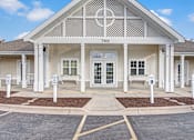 Thumbnail 1 of 44 - A white building with a porch and a sign that says 7960.