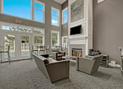 Thumbnail 10 of 44 - A living room with a fireplace and a couch.