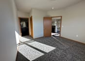 Thumbnail 15 of 34 - A room with a carpet and a door.