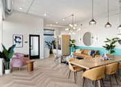 Thumbnail 16 of 21 - A modern dining room with a wooden table and chairs.