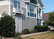Thumbnail 3 of 44 - A house with a grey siding and a white trim.