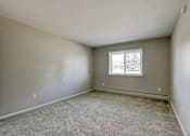 Thumbnail 20 of 31 - A room with a carpeted floor and a window.