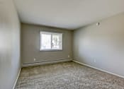 Thumbnail 19 of 31 - A room with a window and carpeted floor.