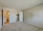 Thumbnail 26 of 31 - A room with a carpeted floor and white walls.