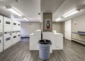 Thumbnail 9 of 27 - A large room with a trash can in the middle of it.