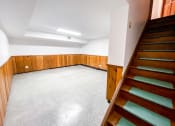 Thumbnail 17 of 27 - a empty room with wooden stairs and a white floor