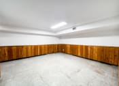 Thumbnail 16 of 27 - an empty room with wood paneling on the walls and a tile floor