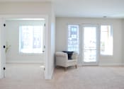 Thumbnail 15 of 31 - A living room with a couch and a plant.