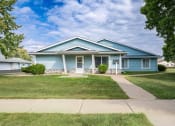 Thumbnail 18 of 19 - the front of a blue house with a sidewalk and grass