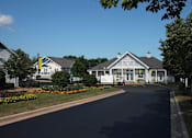 Thumbnail 5 of 44 - A street view of a residential area with houses and a clear blue sky.