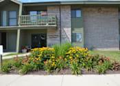 Thumbnail 18 of 21 - a house with a flower garden in front of it