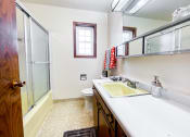 Thumbnail 23 of 27 - a bathroom with a sink and a shower and a toilet