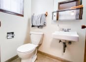 Thumbnail 22 of 27 - a bathroom with a toilet sink and mirror and a window