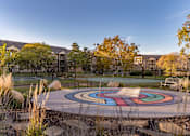 Thumbnail 30 of 43 - A colorful circular design is in the middle of a park.