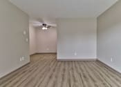 Thumbnail 2 of 21 - an empty living room with hardwood floors and a ceiling fan