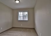 Thumbnail 6 of 21 - the spacious living room of an empty house with a window