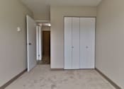 Thumbnail 5 of 21 - a bedroom with two closets and a carpeted floor