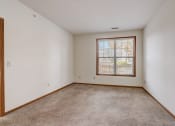 Thumbnail 28 of 102 - an empty living room with a window and carpet