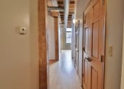 Thumbnail 27 of 35 - a hallway with wooden doors and a wood floor