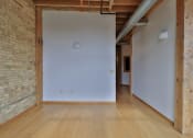 Thumbnail 29 of 35 - an empty room with a white wall and wood floors