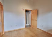 Thumbnail 33 of 35 - an empty room with a wooden floor and an open door