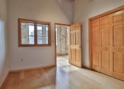 Thumbnail 31 of 35 - an empty living room with wooden doors and windows