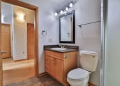 Thumbnail 34 of 35 - a bathroom with a toilet and a sink and a mirror