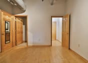 Thumbnail 22 of 35 - an empty living room with wooden floors and wooden doors