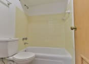 Thumbnail 16 of 33 - a bathroom with a toilet and a bath tub