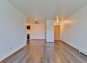 Thumbnail 20 of 33 - an empty living room with wood floors and white walls