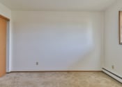 Thumbnail 23 of 33 - A room with a carpeted floor and a door on the left.