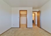 Thumbnail 27 of 33 - an empty bedroom with a walk in closet and a hallway to a bedroom