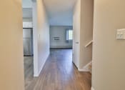 Thumbnail 22 of 43 - a view of a living room and kitchen with wood floors