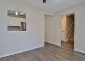 Thumbnail 21 of 43 - the living room and kitchen of an empty apartment with wood flooring