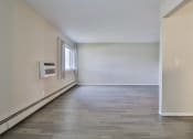 Thumbnail 29 of 43 - an empty living room with white walls and a window