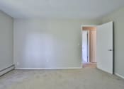 Thumbnail 36 of 43 - an empty living room with white walls and a door to a hallway