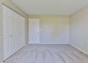 Thumbnail 11 of 15 - an empty bedroom with white walls and white doors