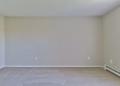 Thumbnail 12 of 15 - an empty room with beige walls and a tiled floor