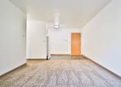 Thumbnail 5 of 11 - A carpeted hallway with a white door and a brown door.