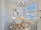 Thumbnail 5 of 102 - A dining room with a round table and chairs.