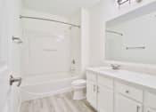 Thumbnail 13 of 102 - A white bathroom with a toilet, sink, and bathtub.