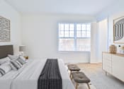 Thumbnail 14 of 102 - A bedroom with a large bed and a window with blinds.